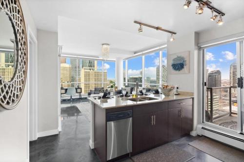a kitchen with a sink and a large window at Urbanest - Spectacular Views & Amenities Parking in Calgary
