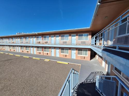 an empty parking lot in front of a building at Leisure Lodge Motel in Grants