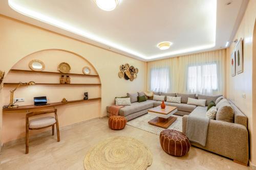 a living room with a couch and a table at Babylone Appart & Pool, Hivernage in Marrakech