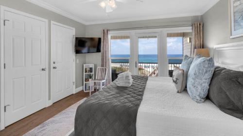 a bedroom with a bed with a view of the ocean at Sea Haunts 1A in Santa Rosa Beach