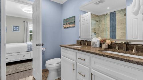 a white bathroom with a toilet and a sink at Sea Haunts 1A in Santa Rosa Beach