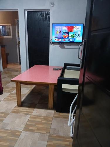 una camera con tavolo e TV a parete di Alojamiento B&B Corrientes a Corrientes