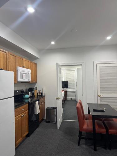 a kitchen with a white refrigerator and a table at Gorgeous Refurbished 1Bdrm and 1Den Home in Washington, D.C.