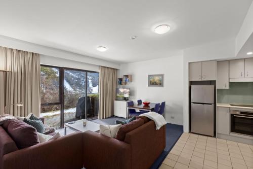 a living room with two couches and a kitchen at Lantern 02 Patio in Thredbo