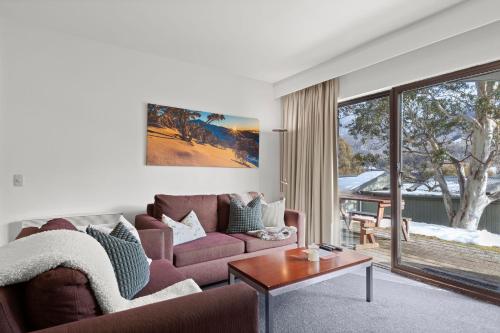a living room with a couch and a table at Lantern 02 Patio in Thredbo
