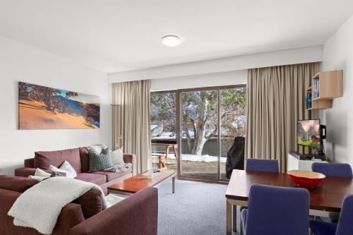 a living room with a couch and a table at Lantern 02 Patio in Thredbo