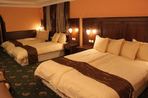 Cette chambre d'hôtel comprend 2 lits avec des draps blancs. dans l'établissement Stoichkovata Kashta Koprivshtitsa, à Koprivchtitsa