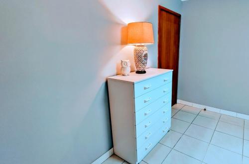a lamp on top of a dresser in a room at Helen's Cosy House In Miller in Mount Pritchard