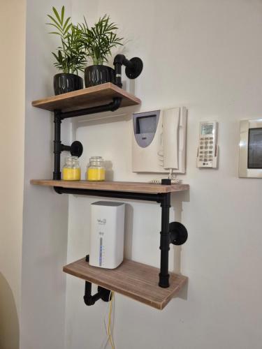a shelf with a computer and a printer on a wall at Factory 219 Apartment Guidonia in Guidonia