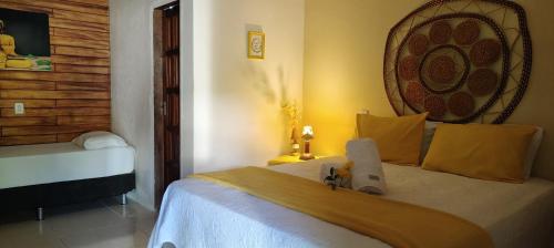 a bedroom with a bed in a room at Chalés da Cris in Fortim