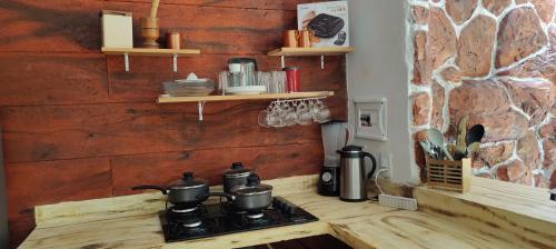 a stove with pots and pans on a counter in a kitchen at Chalés da Cris in Fortim