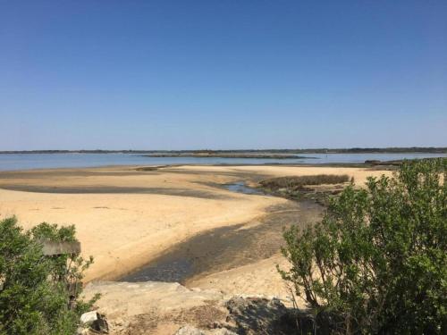 a sandy beach with a body of water at Peaceful Villa in Castle Park in Salles