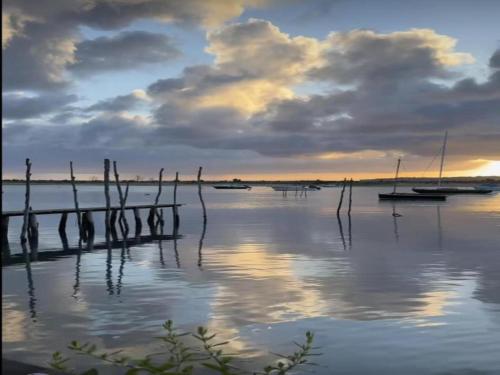a sunset over a body of water with boats at Villa in France with Private Garden in Salles