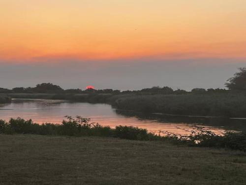 a river with a sunset in the background at Villa in France with Private Garden in Salles