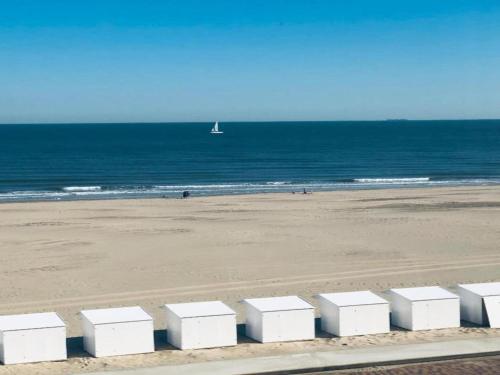 a row of white boxes on the beach at Villa in Wenduine near the Beach in Wenduine