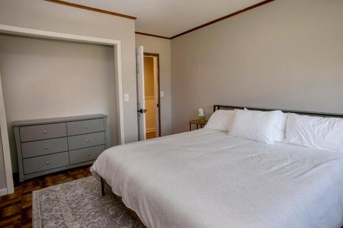 a bedroom with a large bed with white sheets and pillows at Norris View in Dundee