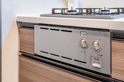 a microwave oven sitting on top of a counter at Apartment Hotel 11 Higashi Umeda in Osaka