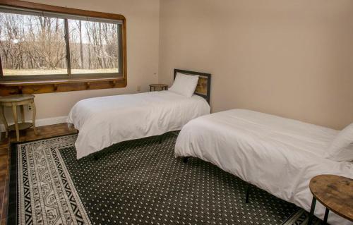 a bedroom with two beds and a window at Norris View in Dundee