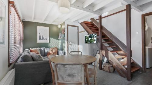 a living room with a table and a couch at Alpine Retreat in Dinner Plain