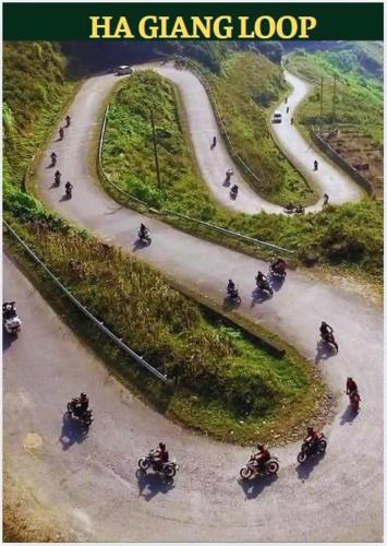 a group of people riding motorcycles down a road at Tam Coc Guest House & Hostel in Ninh Binh