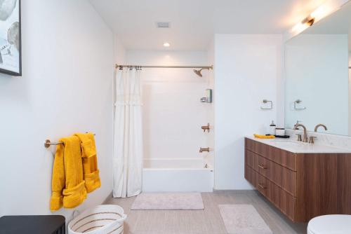a white bathroom with a shower and a sink at Back-Bay Upscale Central Condo Rooftop & Parking in Boston