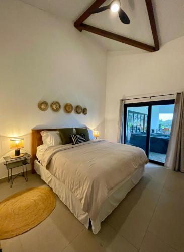 a bedroom with a large bed and a large window at La Casita 4BR Private Paradise with Pool in La Garita