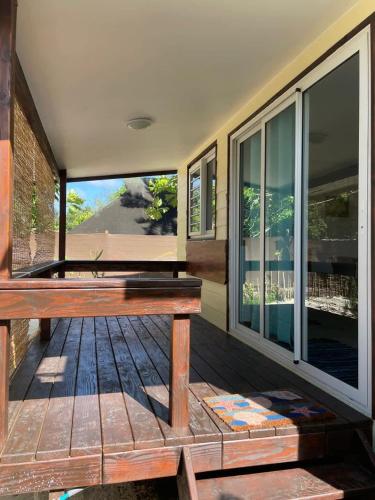a wooden bench sitting on the porch of a house at Matira Beach Raitea 3 in Bora Bora