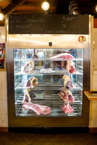 a display of meat in a display case in a store at Over Dream 