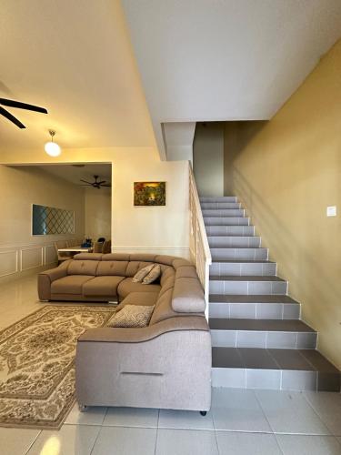a living room with a bed and a staircase at Nameera Stay Bandar Universiti Seri Iskandar in Seri Iskandar