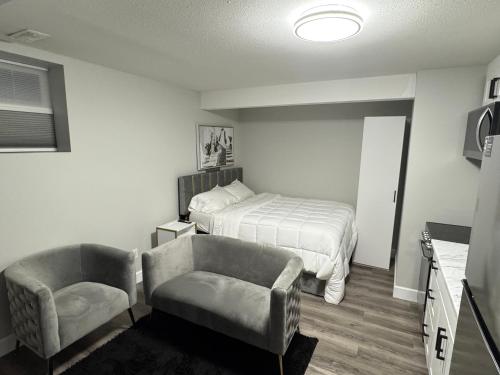 a bedroom with a bed and a chair at True Haven in Prince George