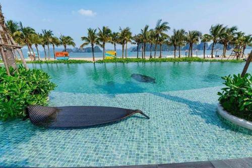 a large swimming pool with a boat on the ground at Rosa Villa - Sonasea - Vân Đồn in Thâm Câu