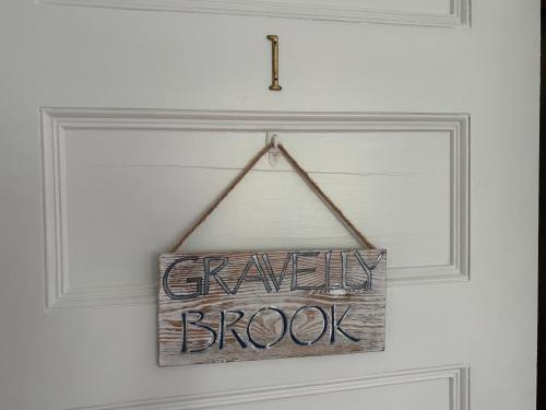 a sign that says crazy brook hanging on a door at The Harbor Inn in Kennebunkport