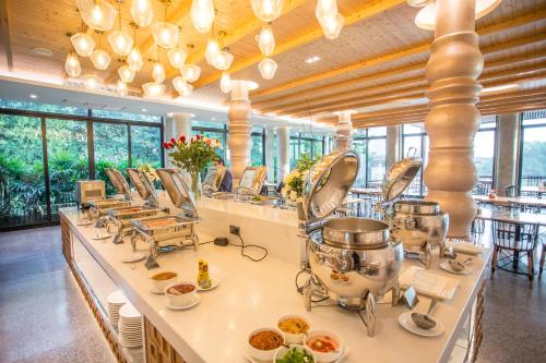 a kitchen with several pots and pans on a counter at Rachabhura Hotel in Ratchaburi