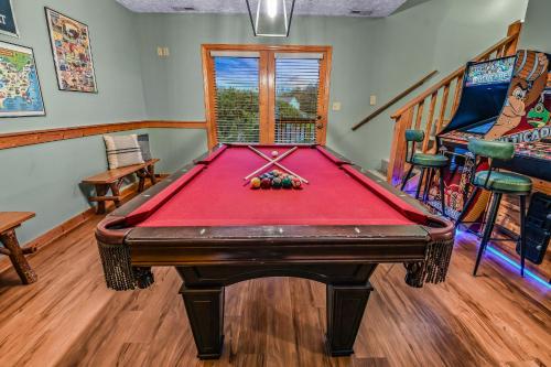 a room with a pool table in a house at Smoky Peak Retreat in Pigeon Forge