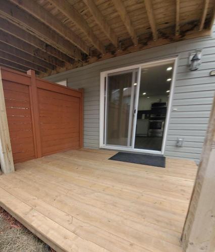 a patio with a sliding glass door on a house at Spacious Basement Suite NW Calgary- 1bedroom 2 guest maximum in Calgary