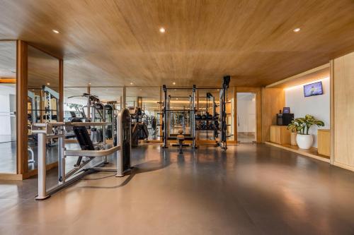 a gym with treadmills and machines in a room at Bali Beach Hotel in Sanur