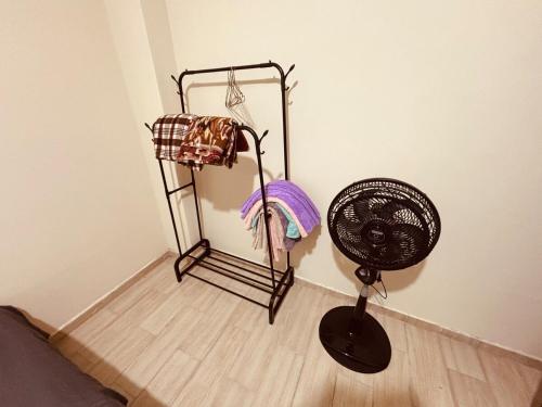 a corner of a room with a fan next to a wall at Cri 50 in Tena