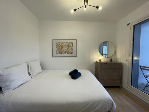 une chambre avec un grand lit blanc et une fenêtre dans l'établissement Apartment in Le Mans near Train Station, au Mans