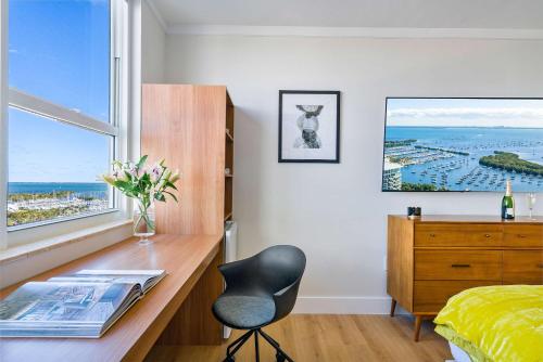 a bedroom with a desk and a chair and a window at MVR Relax in Suite with Biscayne Bay Sunsets in Miami