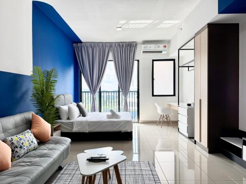 a living room with a couch and a bed at Alinea Suites by Moka in Shah Alam