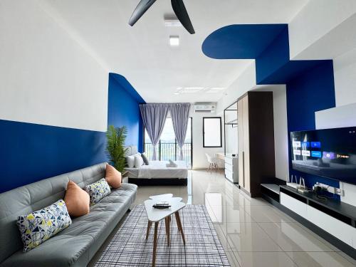 a blue and white living room with a couch and a table at Alinea Suites by Moka in Shah Alam