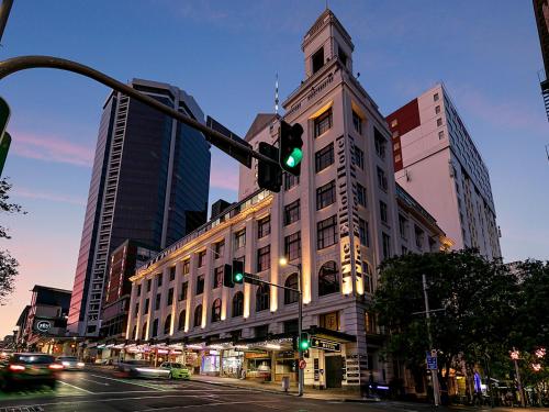 a green traffic light in front of a building at Attic Backpackers in Auckland