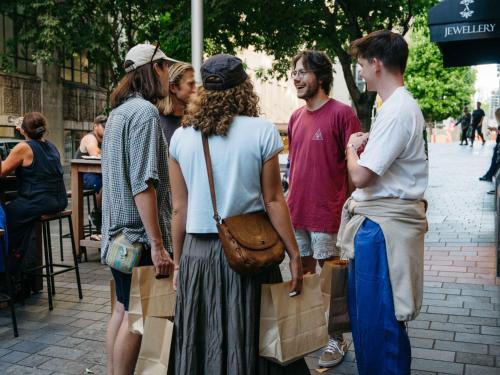 a group of people standing on a sidewalk at Attic Backpackers in Auckland