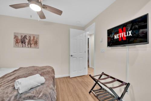 a living room with a bed and a flat screen tv at A Refined Retreat in Lackawaxen