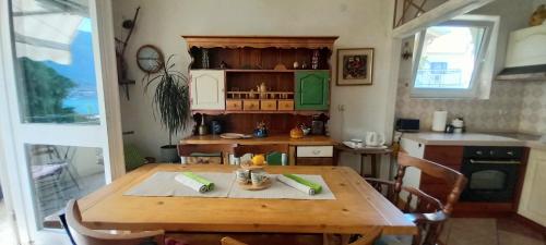a kitchen with a wooden table and a dining room at Apartment Navigator's lodging in Kotor