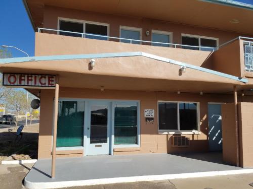 a office building with a sign in front of it at Leisure Lodge Motel in Grants