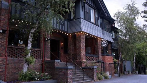 a brick building with a clock on the side of it at Alpine Hotel, Eat Drink Sleep in Warburton