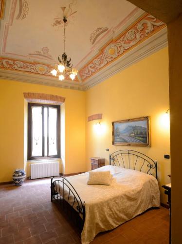 a bedroom with a bed in a yellow room at Palazzo Centro Alloggi Vacanza in Nizza Monferrato