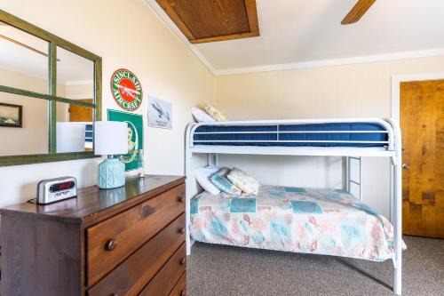 a bedroom with a bunk bed and a dresser at 7097 - Kickin` Back in Nags Head