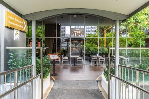 an entrance to a building with tables and chairs at Hotel Traveltine in Singapore